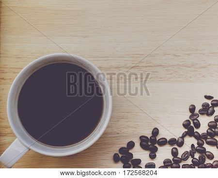 coffee bean and coffee mug on wood background