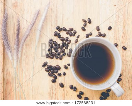 coffee bean and coffee mug on wood background