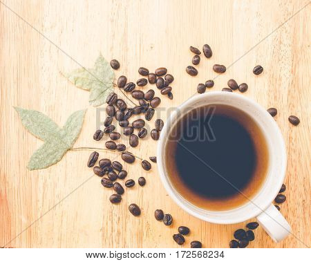 coffee bean and coffee mug on wood background