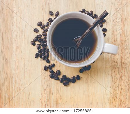coffee bean and coffee mug on wood background