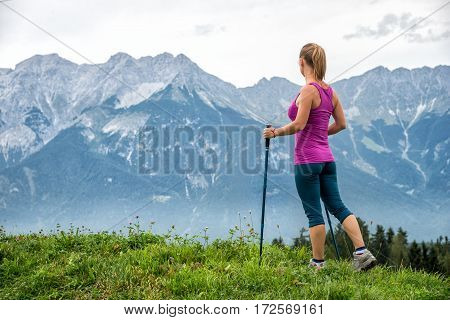 Young woman without backpack hiking in the mountains Alps. Austria. Insbruk