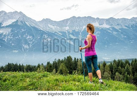 Young woman without backpack hiking in the mountains Alps. Austria. Insbruk