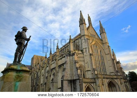 WINCHESTER, UK - FEBRUARY 4, 2017: Exterior view of the Cathedral with the statue of First World War Soldier in the foreground