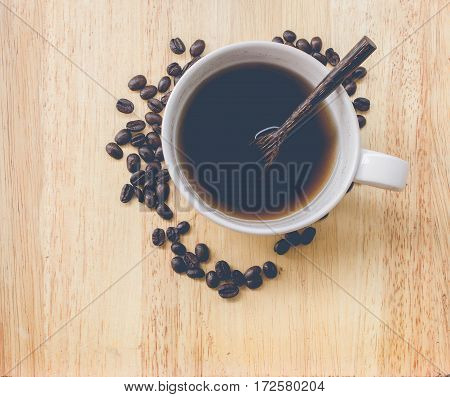 coffee bean and coffee mug on wood background