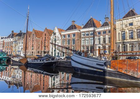 GRONINGEN, NETHERLANDS - FEBRUARY 15, 2017: Old ships and warehouses in the historical center of Groningen, Netherlands