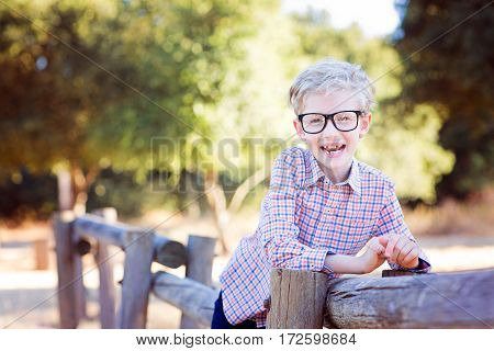 cute school boy student in glasses enjoying time outdoor back to school concept
