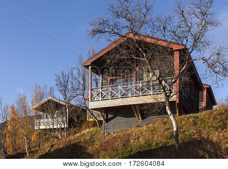 LAPLAND, SWEDEN ON SEPTEMBER 21. Modern, wooden cabin, lodge close to the Hotel Fjallet on September 21, 2016 in Lapland, Sweden. Sunny morning in the autumn, fall. Editorial use.