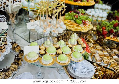 Differrent Cup Cakes At Wedding Reception Table.