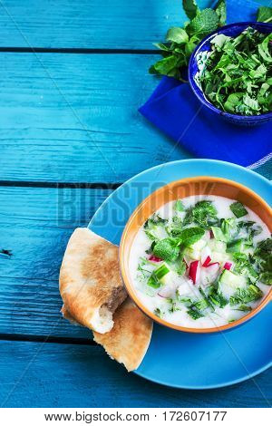 Azerbaijani/russian Cold Soup With Greens On Blue Wooden Background.