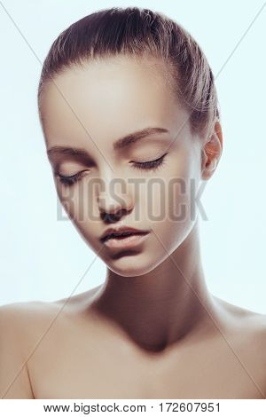 Front portrait of beautiful face with beautiful closed eyes - isolated on white. Close-up fashion portrait of young caucasian model with perfect skin. Photo of attractive teen girl