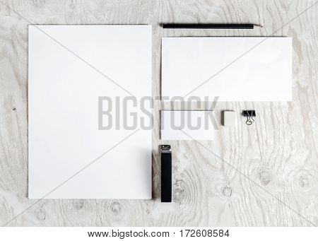 Photo of blank stationery set. Corporate identity template on light wooden background. Mock up for placing your design. Responsive design mockup. Top view.