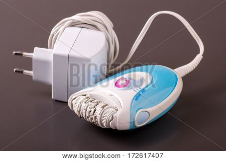 electric epilator or depilator hair on a dark background. Hair removal device