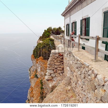 The building of the lighthouse on the cliff at Cape Formentor. Majorca, Spain.