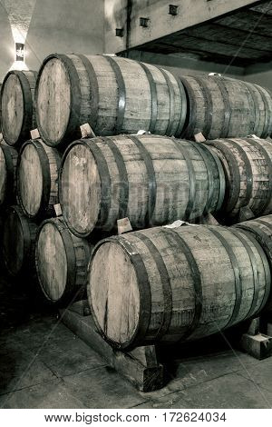 Wine Barrels Stacked In The Old Cellar Of The Winery.