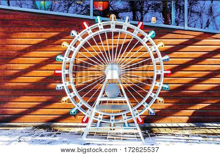 Layout part ferris wheel on a wooden background with free space