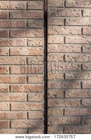 Vertical expansion joint makes allowance for thermal expansion of the parts joined without fracture or fissure. Dilatation joint between two blocks of buildings