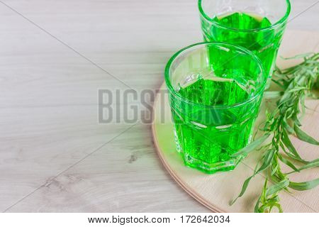 Water With Tarragon On A Wooden Surface