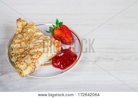 Pancakes With Strawberries On A Wooden Background