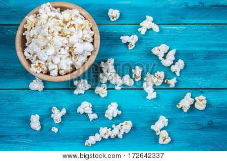 Popcorn In Wooden Plate On A Blue Background