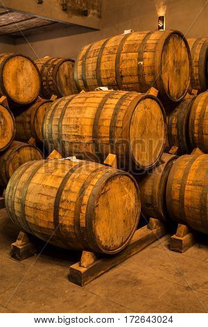 Wine Barrels Stacked In The Old Cellar Of The Winery.