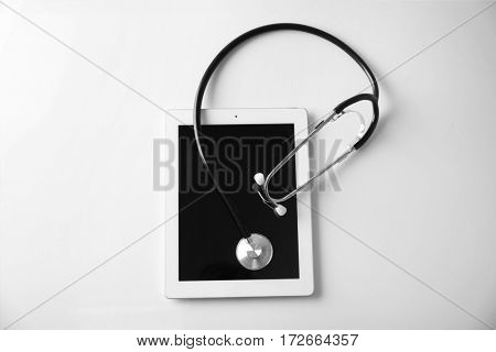 Stethoscope and tablet pc on white background