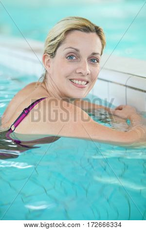 Blond woman relaxing in spa pool