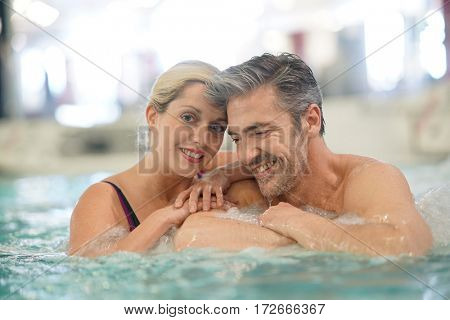 Couple relaxing in thalassotherapy hot tub