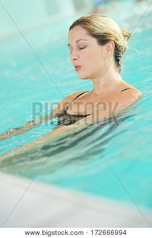 Blond woman relaxing in spa pool