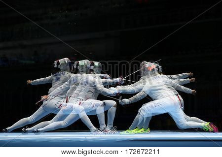 RIO DE JANEIRO, BRAZIL - AUGUST 13, 2016: Sofya Velikaya of Russia (L) and Mariel Zagunis of United States compete in the Women's Sabre Team of the Rio 2016 Olympic Games at Carioca Arena 3