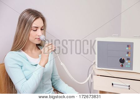 Young woman undergoing light treatment in modern clinic