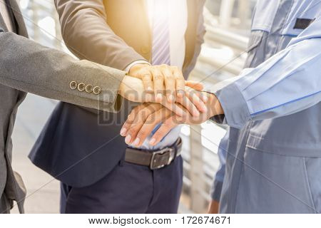 Success Teamwork concept Business people joining hands city background.