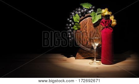 Glass Of Wine And Barrel On Wooden Table