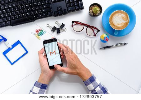 CHIANGMAI THAILAND -JANUARY 92017:Businessman hand holding screen shot of Gmail app showing on iPhone 6s.Gmail is a free e-mail service provided by Google