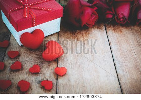 Close up heart red rose and gift box on wooden board with copy space.Valentines Day background concept Wedding day.Vintage tone