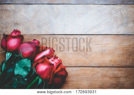 Red roses on wooden background with copy space.Valentines Day background concept Wedding day.Vintage tone