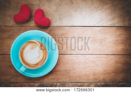 Caption word love heart and cup of coffee on wooden background with copy space.Valentines Day background concept Wedding day.Top view vintage tone