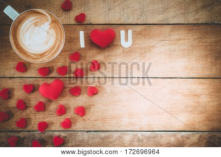Caption word love heart and cup of coffee on wooden background with copy space.Valentines Day background concept Wedding day.Top view vintage tone