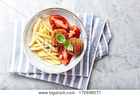Frikadeller with french fries and tomatoes