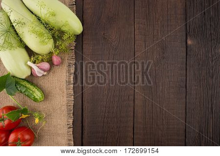 Ripe vegetables on an old wooden table. Top view.