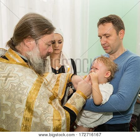 ALMATY KAZAKHSTAN - DECEMBER 17: Christening ceremony on December 17 2013 in Almaty Kazakhstan. Family celebrating baptism in Orthodox Church - Monastery of St. Matrona