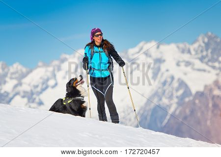 Alpinist Girl On Skis And Sealskins Alone With His Dog Faithful Friend