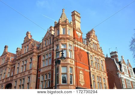 LONDON, UK - FEBRUARY 13, 2017: Red brick Victorian houses facades in S Audley Street (borough of Westminster)