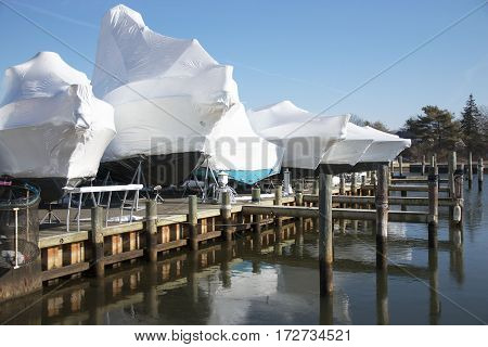 Boats shrink wrapped and stored on the docks for winter