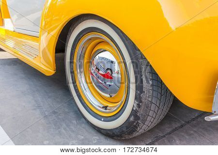 Bangkok Thailand -February 11 2017: The wheel and logo of vintage classic yellow Chevrolet pickup truck shown in vintage automobile festival.