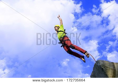 The first jump off the cliff with a safety rope.