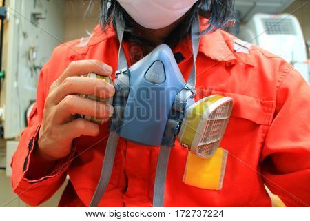 Multi-purpose respirator half mask for toxic gas protection.The man prepare to wear Multi-purpose respirator half mask.