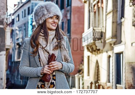 Smiling Young Woman In Venice, Italy In Winter Looking Aside