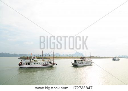 Tourist ships travel through Ha Long bay in Vietnam