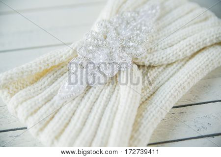 two skeins of wool and knitted headband gradient on the wooden background