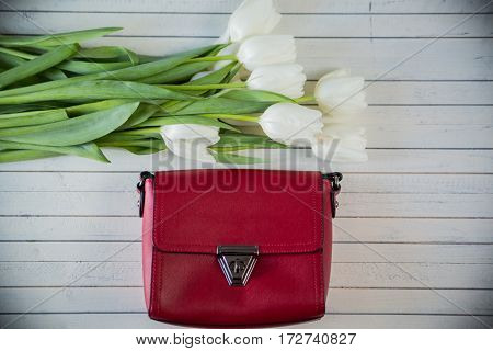 pink woman bag with flowers on wood background